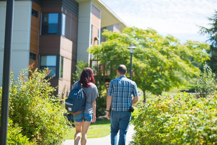 two students walking by student village