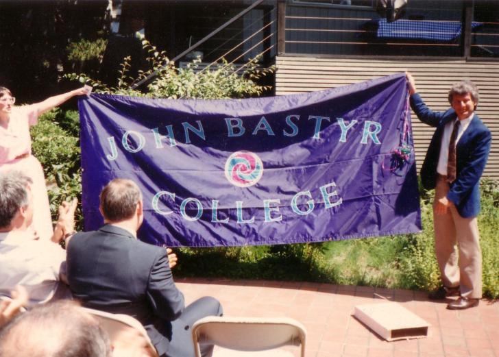 Sheila Quinn and Joseph Pizzorno holding up John Bastyr College banner