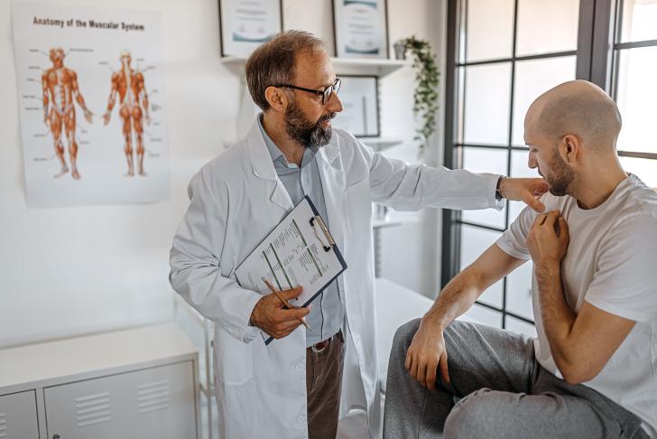 doctor examining patient's arm