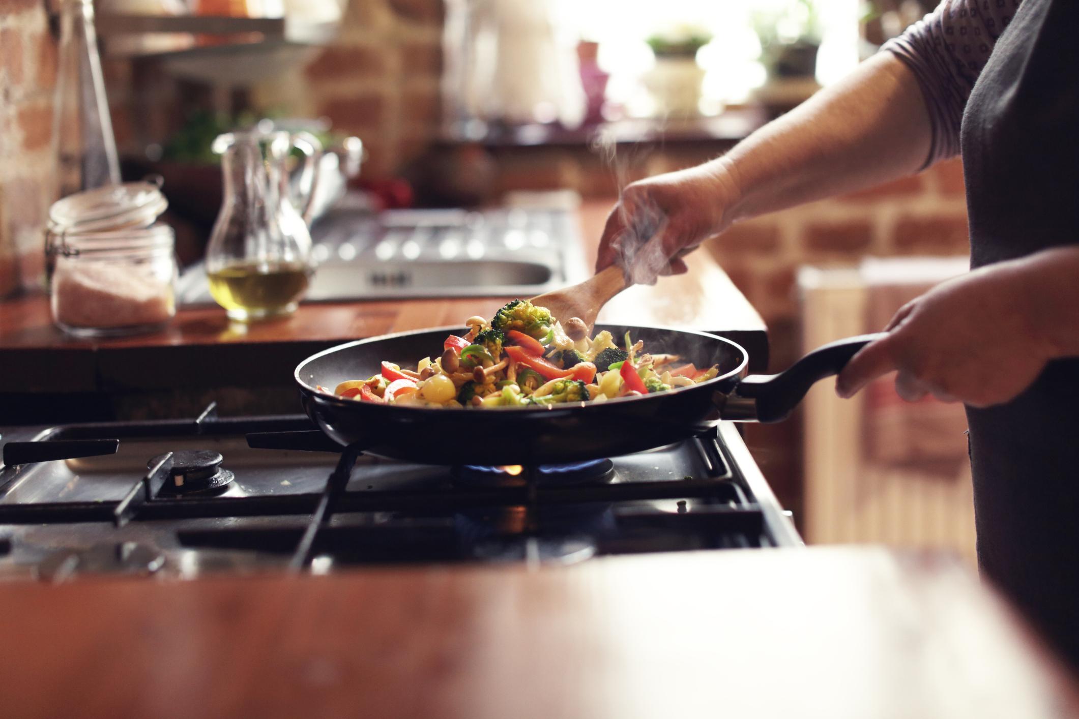 someone cooking stirfry