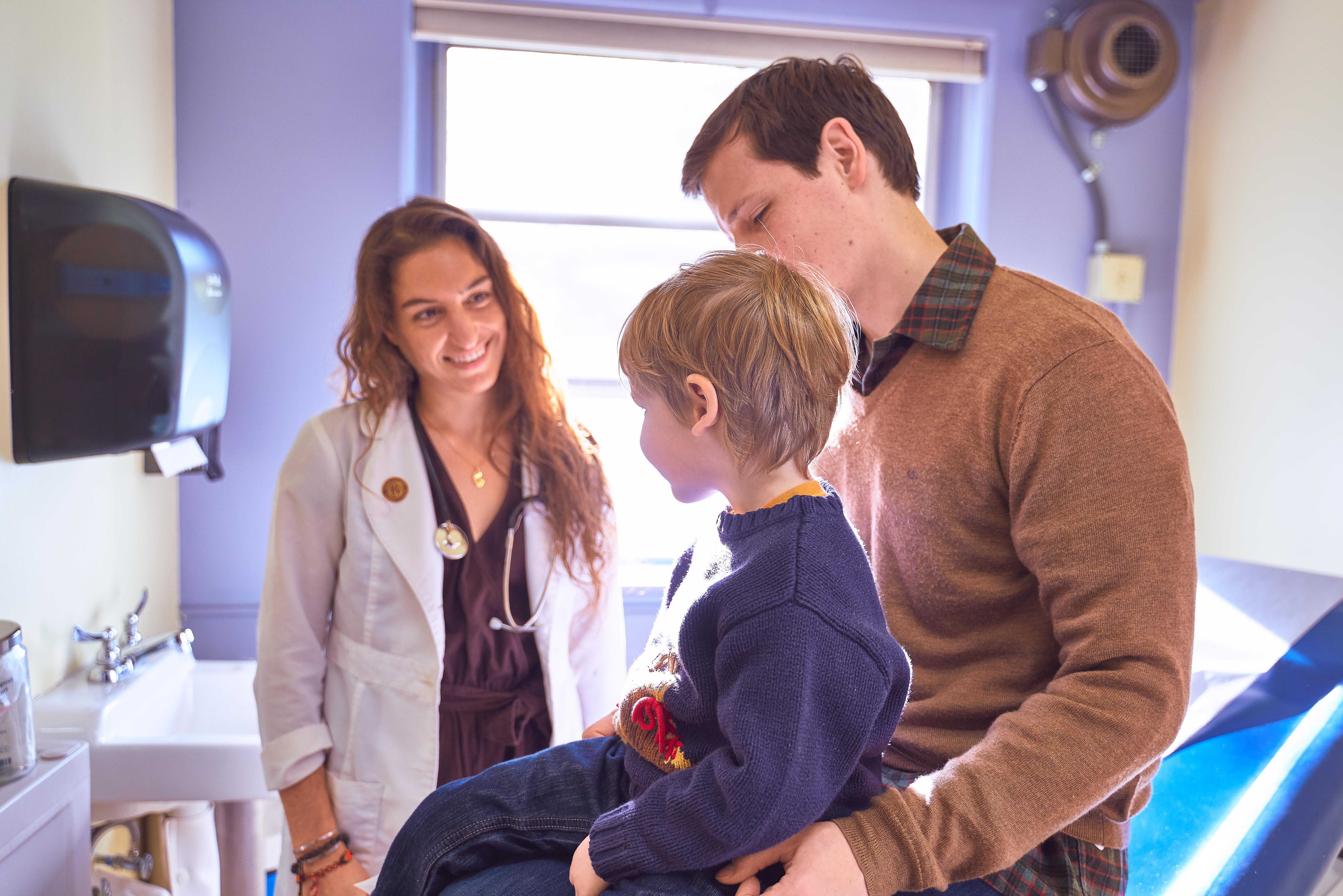 doctor with young child and parent