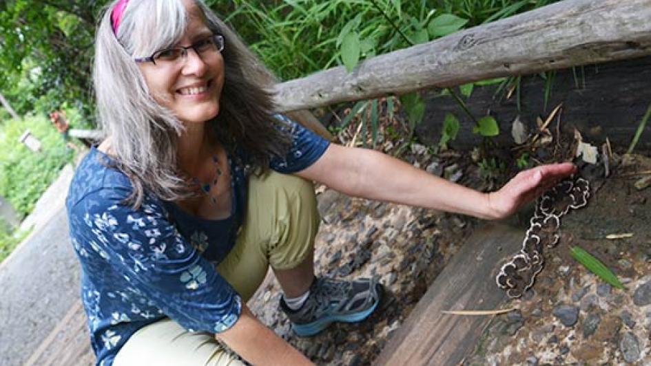 Cindy Wenner crouched by japan mushrooms