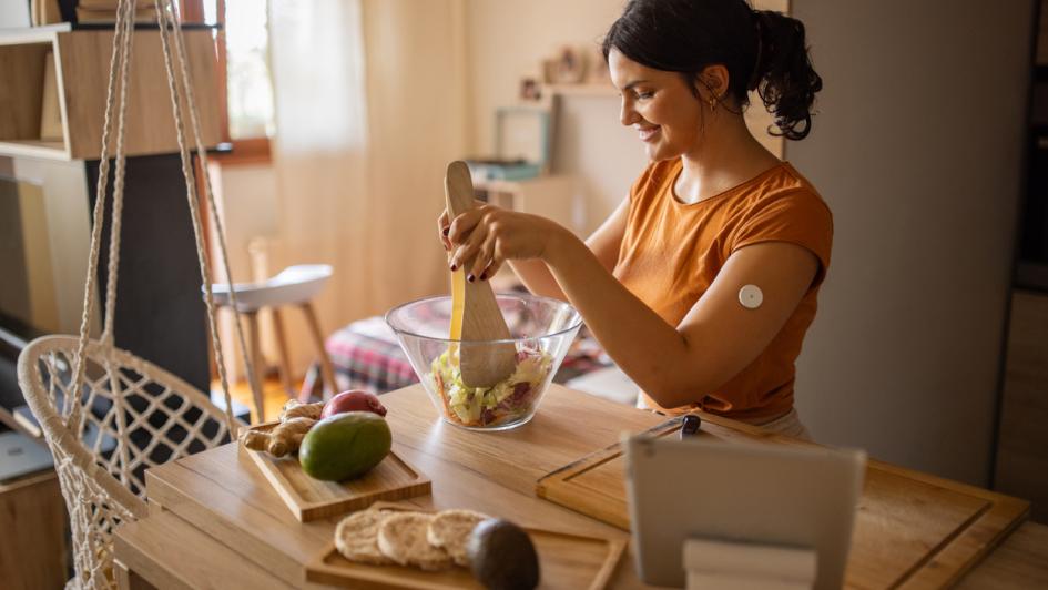 woman with cgm prepares lunch