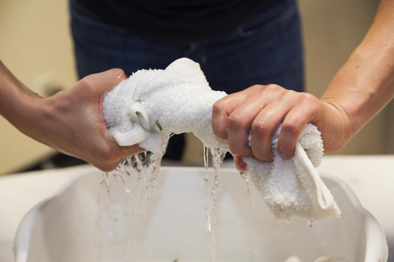 closeup of someone wringing out a cloth